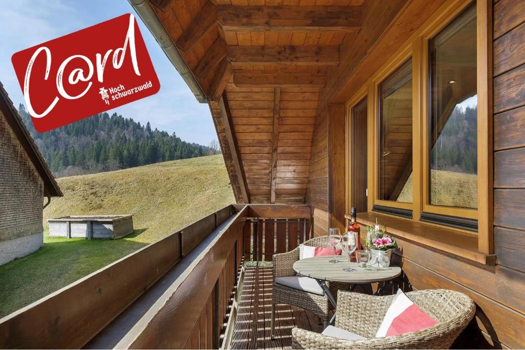 a patio with a table and chairs on a porch at Ferienhaus Hensler in Hinterzarten
