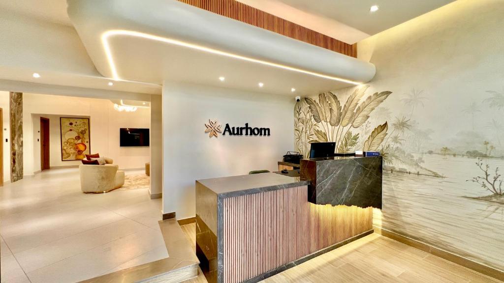 a lobby with a nautilus sign on the wall at Aurhom By Royal Inn in Karachi