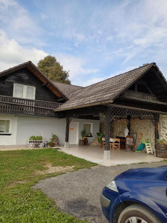 a house with a porch and a patio at David Linea House in Volavlje