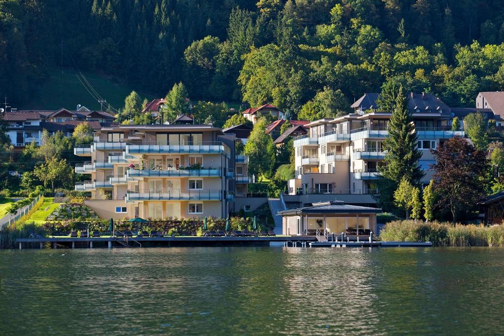a large hotel on the shore of a lake at Apart Hotel Legendär in Steindorf am Ossiacher See