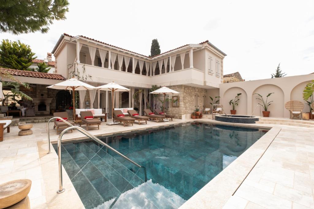 a swimming pool in front of a house at Viento Alacati Hotel in Alaçatı