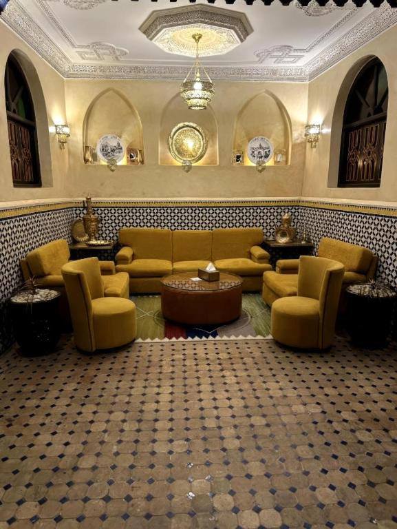a living room with a couch and chairs and a table at Riad Jadis in Marrakesh
