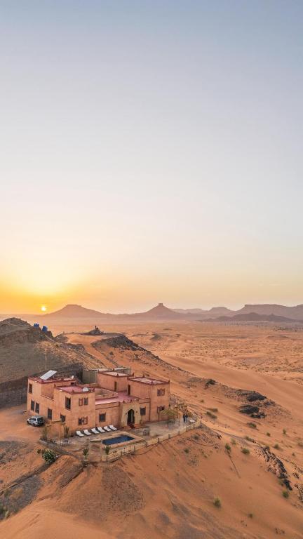 an old building in the desert at sunset at Riad Belvedere in Ouzina