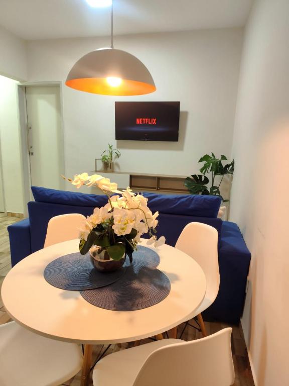 a table with a vase of flowers on it at Haurea House in São Luís