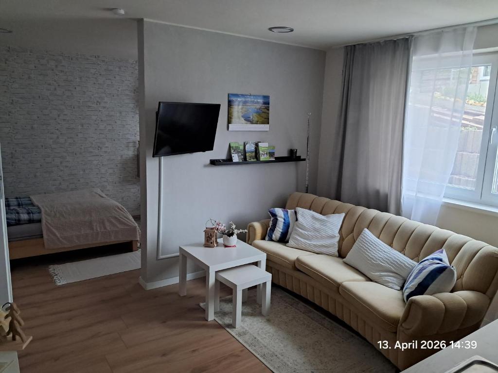 a living room with a couch and a table at Wolfs Studio in Blumberg