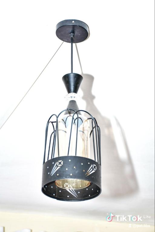 a black bird cage hanging from a ceiling at Rymach homes in Eldoret