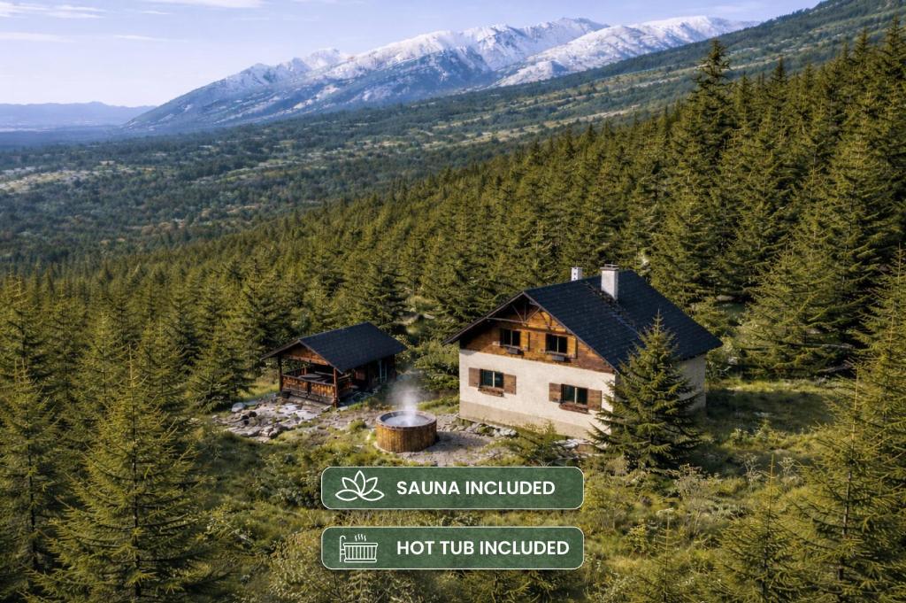a house on the side of a mountain with a sign at Jambrichova chata in Vysoké Tatry