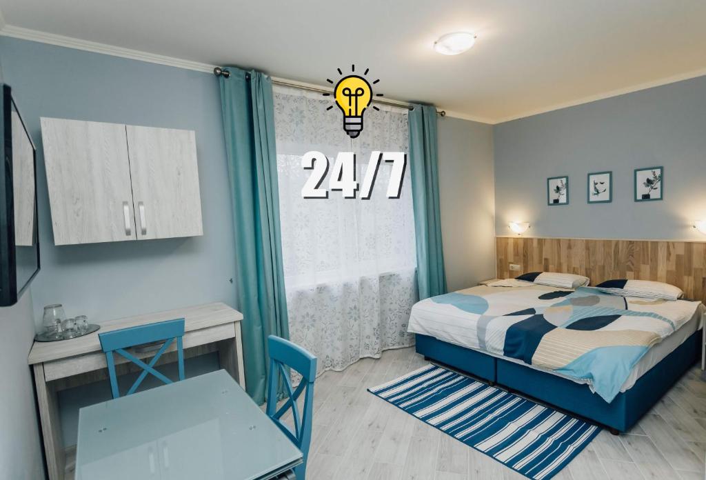 a bedroom with a bed and a table and a desk at Villa Grey House in Berehove