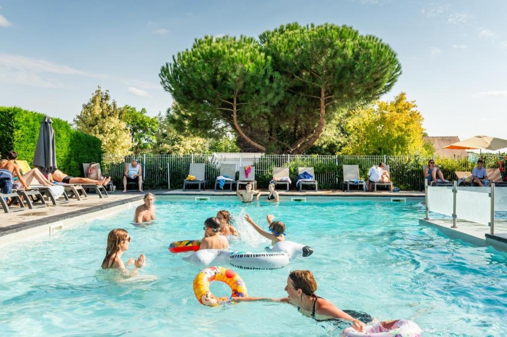 a group of people playing in a swimming pool at Camping Paradis l'Arada Parc in Sonzay