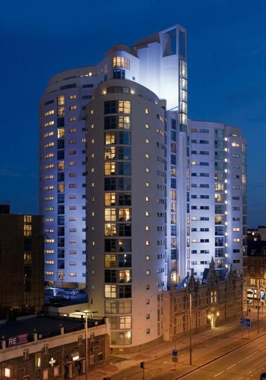 a tall building at night with lights on it at Cardiff City Center - FREE On-Site Parking in Cardiff