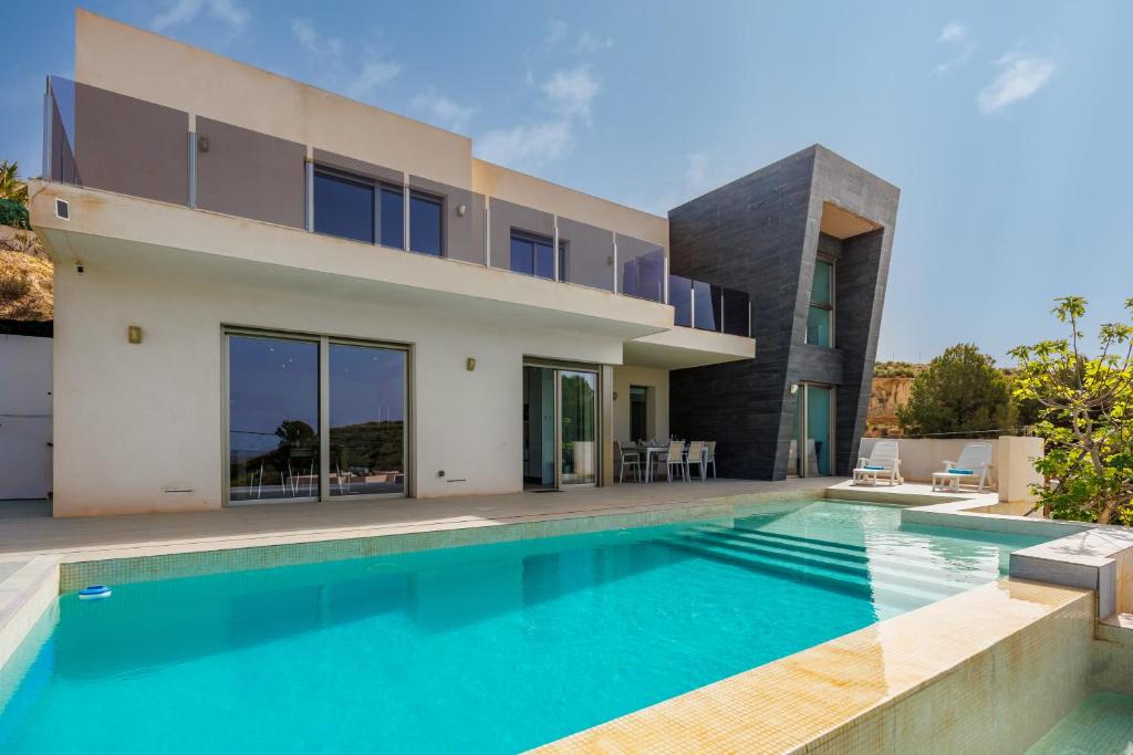 a house with a swimming pool in front of it at Villa Sophia in Busot