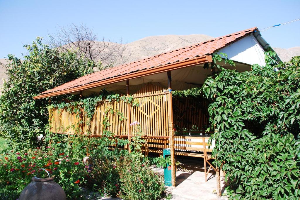 a wooden pavilion with a roof in a garden at Gayane & Khikar B&B in Chʼiva