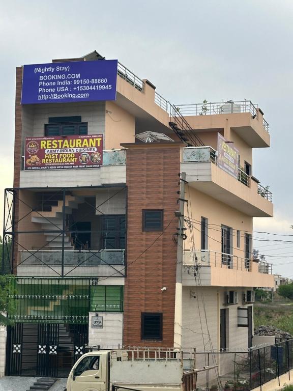 a building with a sign on the side of it at Army cuisine Dine in and LUXURY NIGHTLY STAY Kurali Punjab in Kūrāli