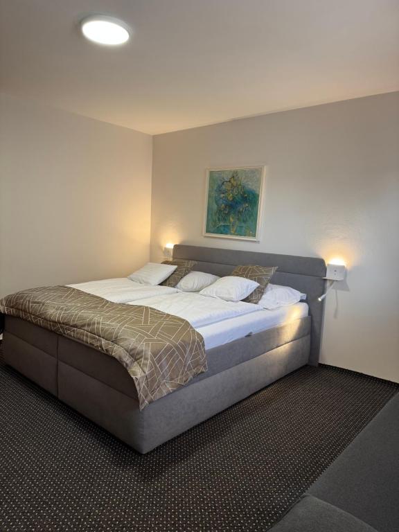 a bedroom with a large bed in a room at Tavel boutique hotel in Prešov