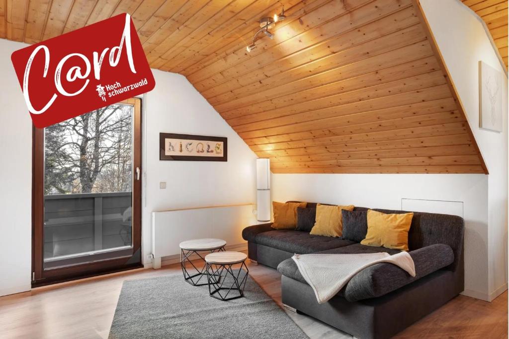 a living room with a couch and a cocacola sign at Ferienwohnung Steinhart in Lenzkirch