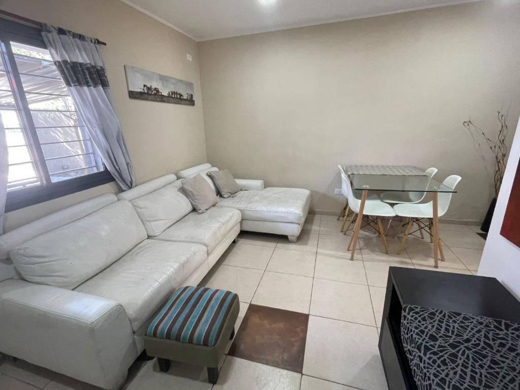 a living room with a white couch and a table at La Buena Memoria in San Juan