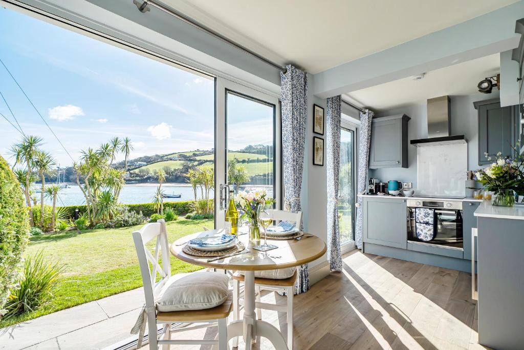 a kitchen and dining room with a table and chairs at No 5 The Salcombe in Salcombe