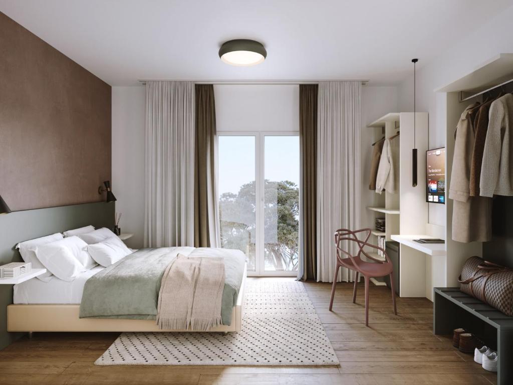 a bedroom with a bed and a large window at Hotel Sayonara in Milano Marittima