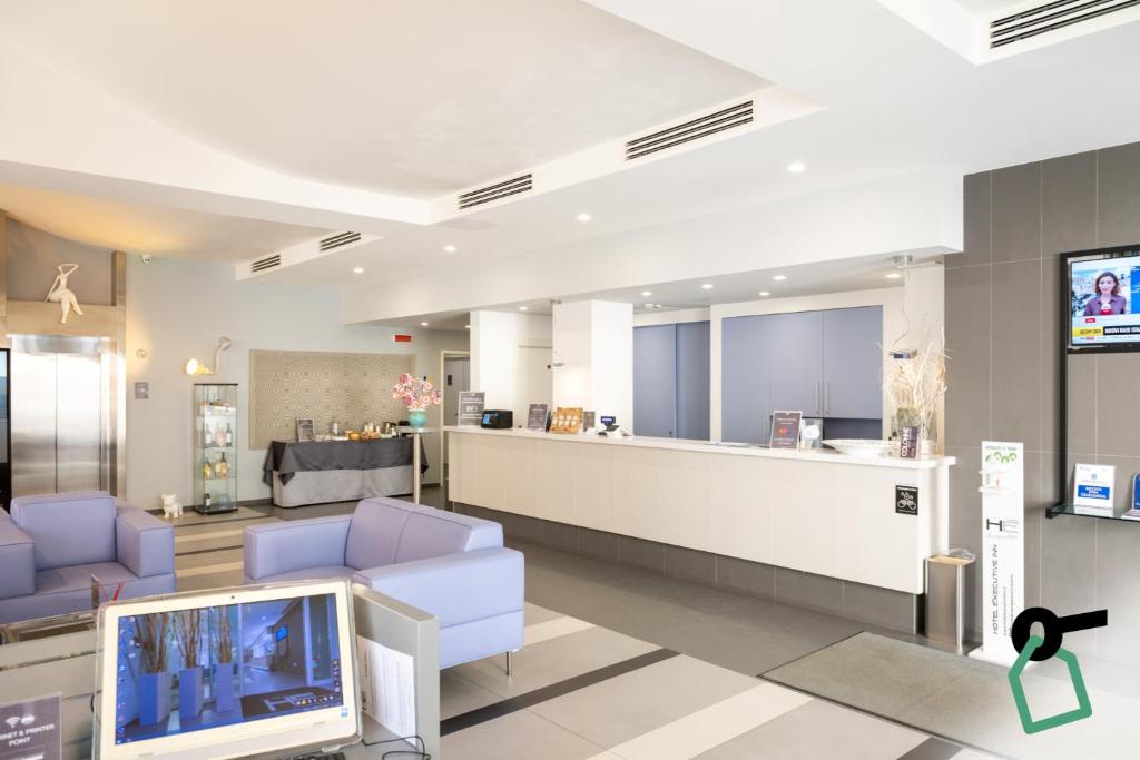 a hospital lobby with a tv and chairs and a counter at Hotiday Brindisi Vittoria in Brindisi