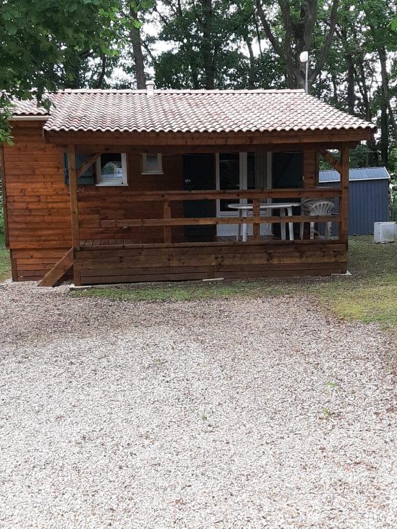a large wooden cabin with a roof at Chalet in Marcilly-sur-Eure