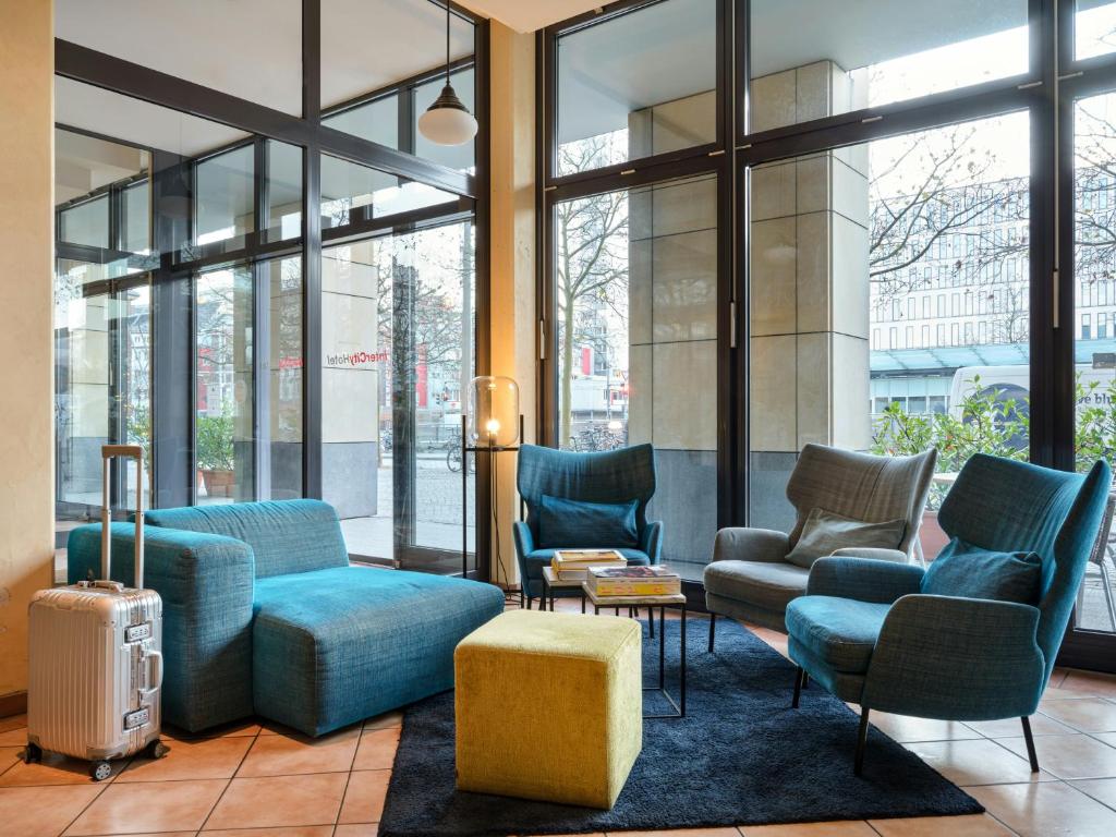 a lobby with couches and chairs in a building at Flemings Hotel Bremen-Hauptbahnhof in Bremen