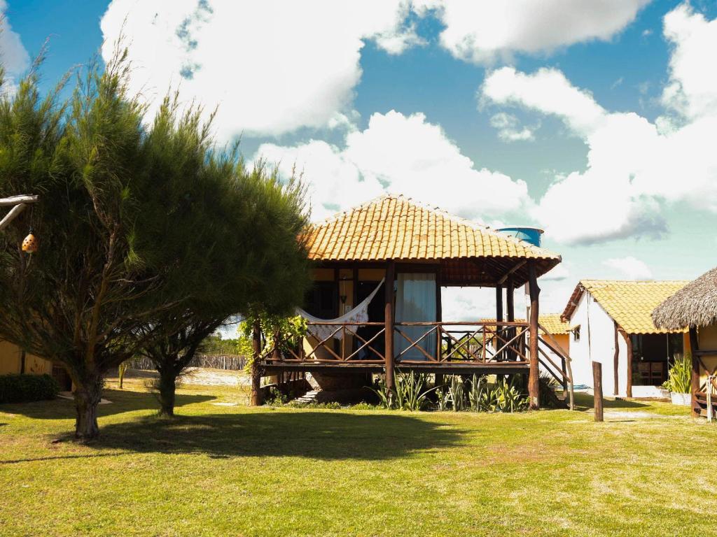 a house with a gazebo in a yard at Vila Riomar in Luis Correia
