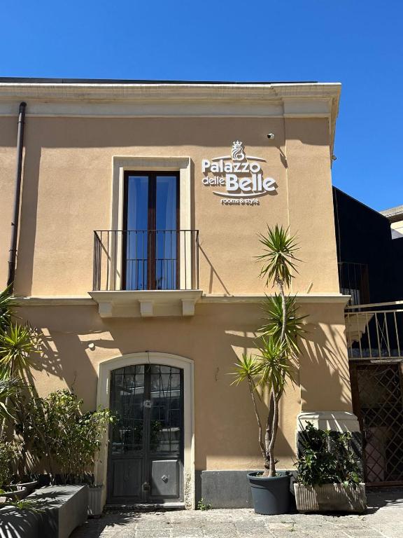 a building with a sign on the side of it at Palazzo delle Belle in Catania