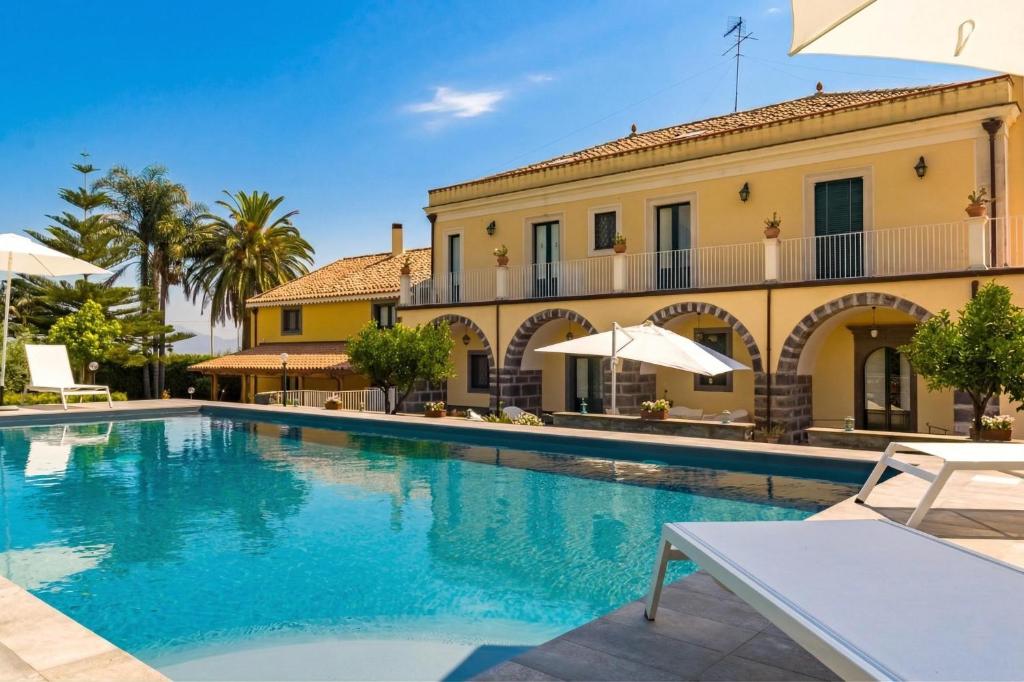 a large swimming pool in front of a building at Villa Solenia in Giarre