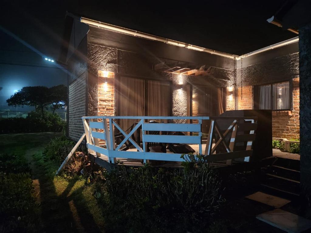 a house with a gate in the yard at night at Ilocavistamar in Iloca