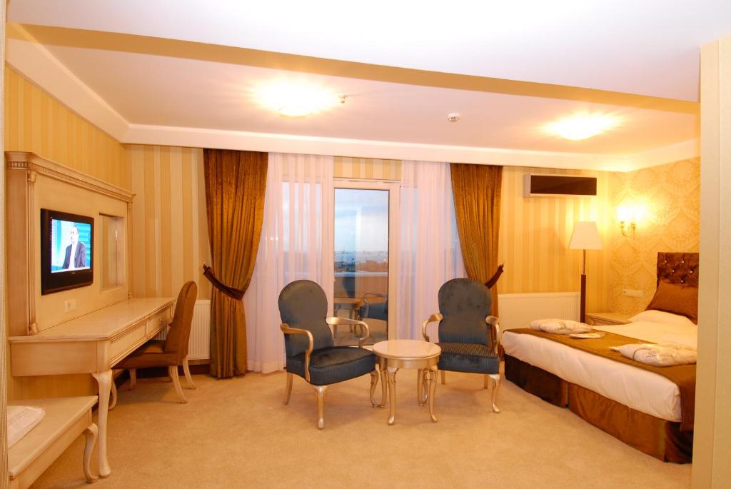a hotel room with a bed and a desk and chairs at Mosaic Hotel Old City -Special Category in Istanbul