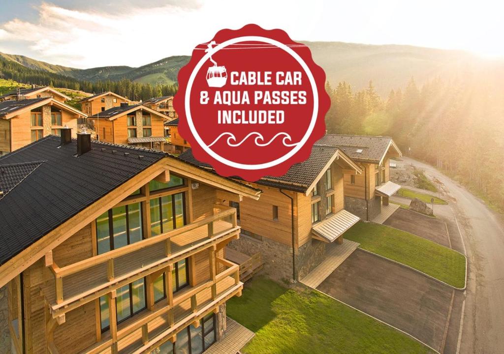 a house with a sign that reads the cubic car and auto passes included at Chalets Jasná Collection Centrum in Belá