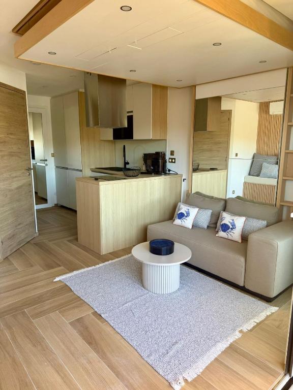 a living room with a couch and a table at Bernard l'Hermite Studio in Gruissan