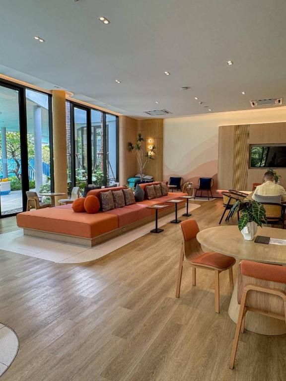 a living room with a couch and a table at Eden D condo reefB244 in Kathu