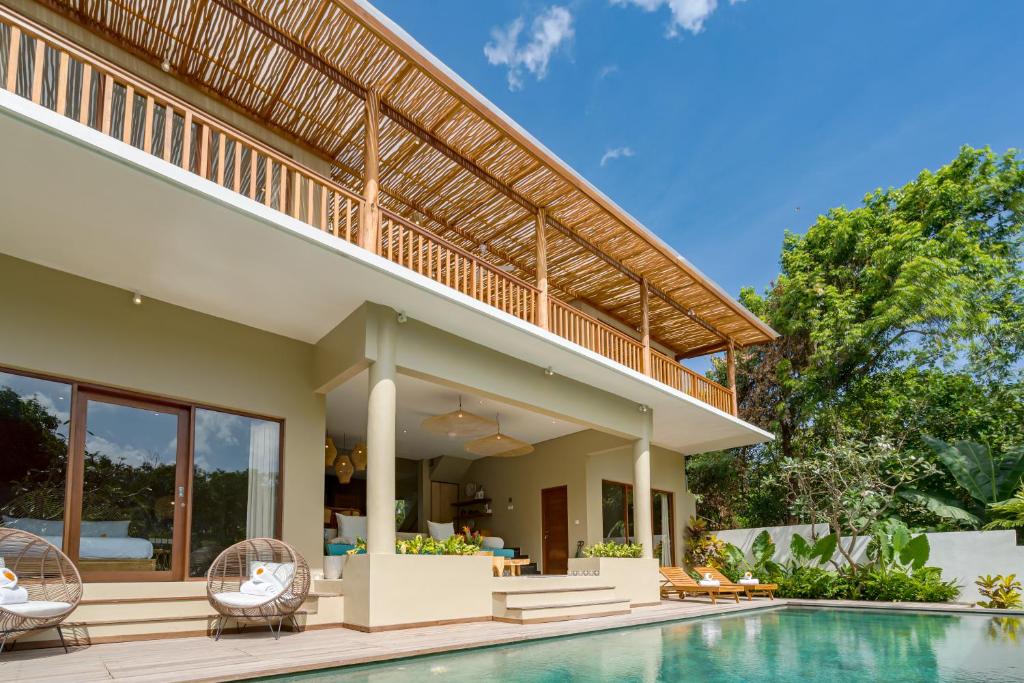 an image of a villa with a swimming pool at Villa Canopy - Spacious Luxury 4BR Villa Near Nuanu and Luna Beach Club in Tabanan