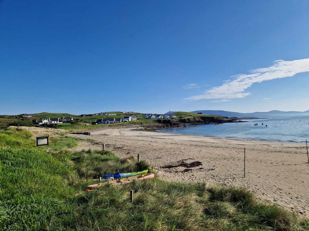 a sandy beach next to a body of water at Beachview Rental in Clare Island