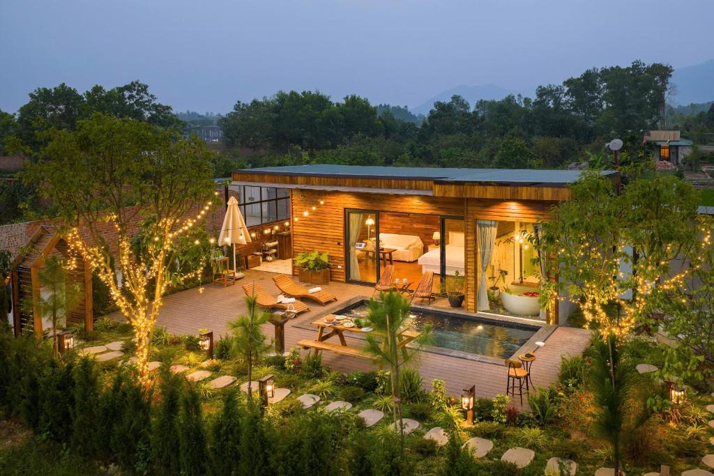 a house with a backyard with a swimming pool at Maia House Homestay in Sóc Sơn