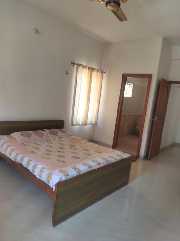 a bedroom with a large bed in a room at Three bedroom villa in Mysore