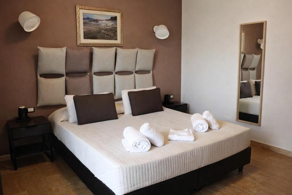 a bedroom with a large bed with towels on it at Hotiday Firenze Vespucci in Florence