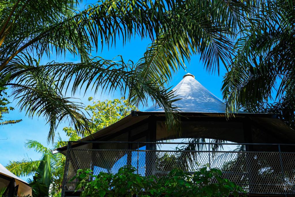 a tip of a building with a palm tree at Seawind Cloudcrest Resort in Semporna