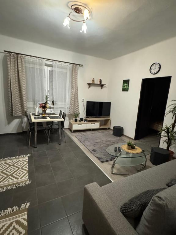 a living room with a couch and a table at Apartment PMS in Veľká Mača