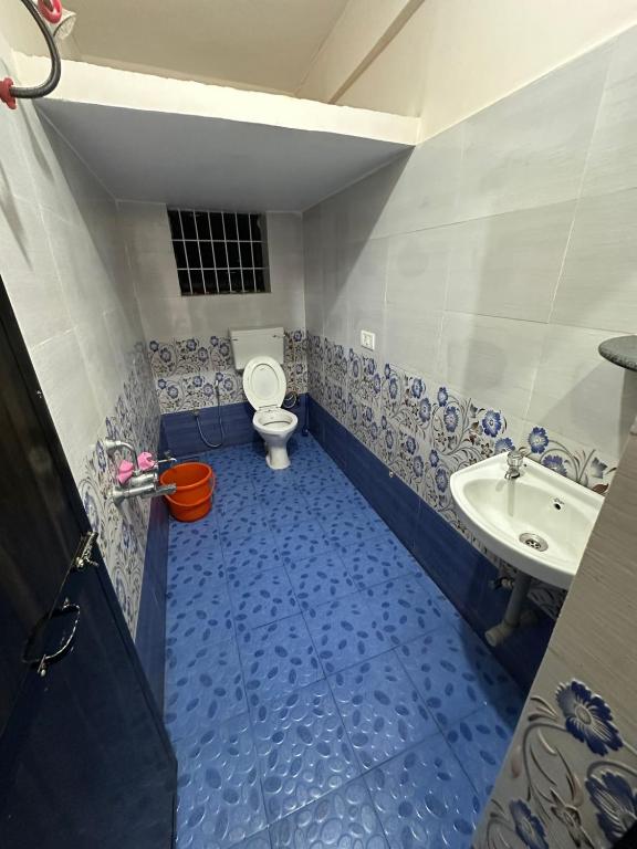 a bathroom with a toilet and a sink at Vinayak guest house in Mandrem