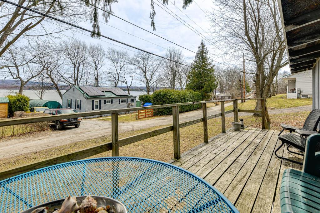 a table on a deck with a view of a house at Steps to St Albans Bay! Basecamp w/ Grill in Saint Albans Bay