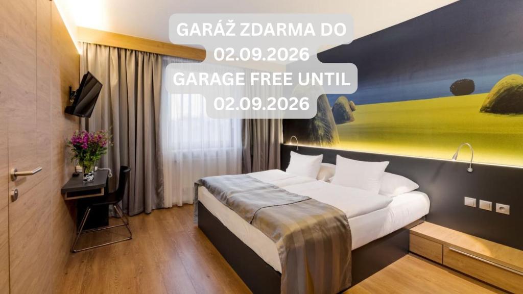 a hotel room with a bed and a sign that reads garage free unit at Expo Hotel in Prague