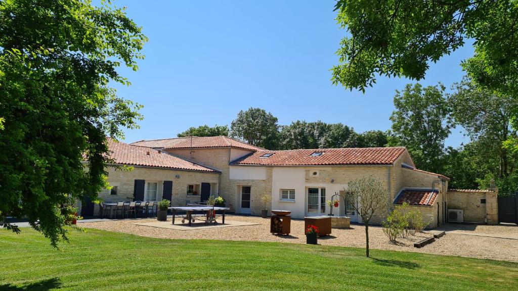 a house with a picnic table in front of it at La Fompatoise in Vérines