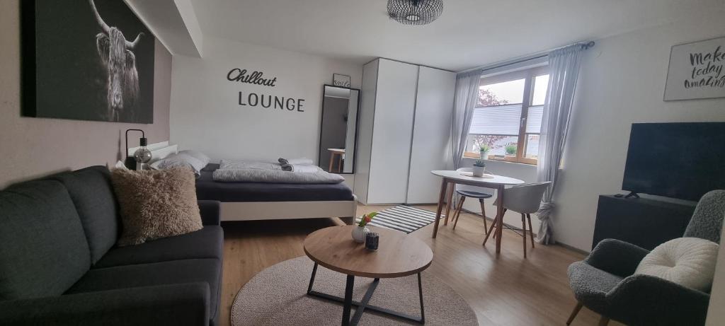 a living room with a couch and a bed and a table at Wohlfühlen in Hohberg in Hohberg