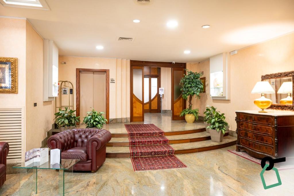 a lobby with a couch and a table and stairs at Hotiday Brindisi Garibaldi in Brindisi