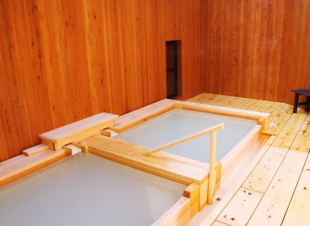 Postel nebo postele na pokoji v ubytování Onsen Yado Misuzuso