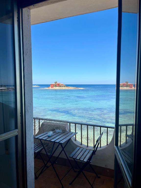 a view of the ocean from a balcony at La terrazza sul mare, 44 in Marzamemi