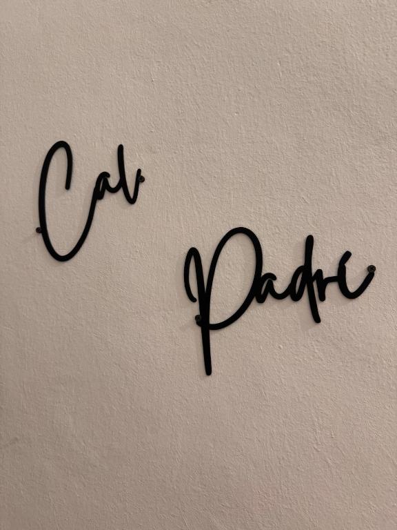 a sign with the word cafe addict written on a wall at Cal Padrí in Caseras