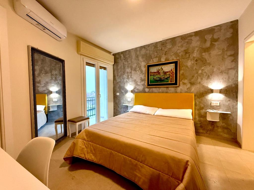 a bedroom with a large bed in a room at B&B Il GLICINE - Uso Cucina e Parcheggio Privato in Sassuolo